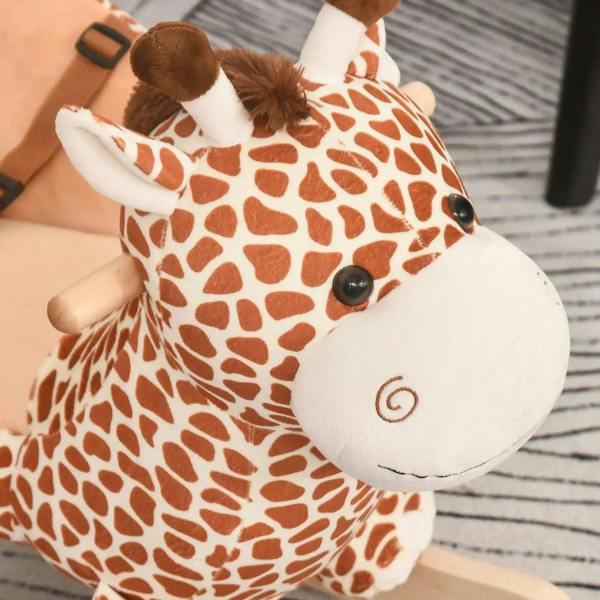 Close-up of giraffe plush rocking horse face with dark eyes and swirl embroidery