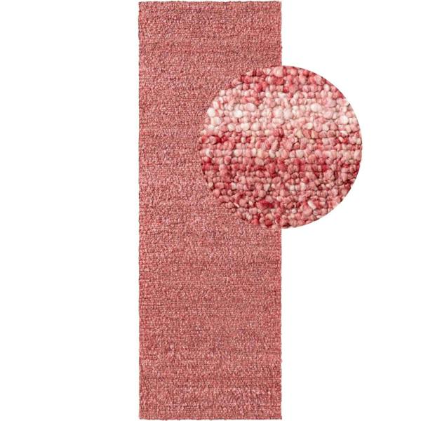 Pink textured rug with a round mat on a white background