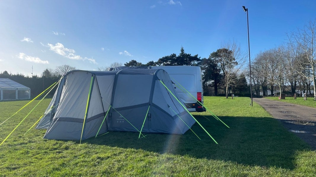 The Cocoon Breeze® XL v2 Motorhome Awning (Grey) from OLPRO pictured in a campsite attached to a VW Crafter Camper Van