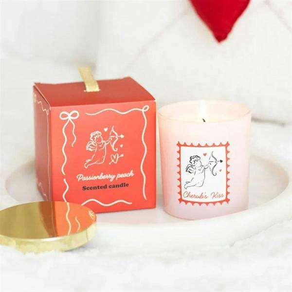 Passionberry peach scented candle in pink jar with gold lid, shown with gift box