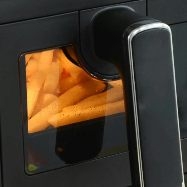Black air fryer viewing window with fries cooking inside and front handle
