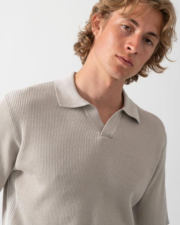close up shot of a Model wearing a BOSS Orange Aravolo Mens Short Sleeve Knit Polo Shirt in Open Grey 070