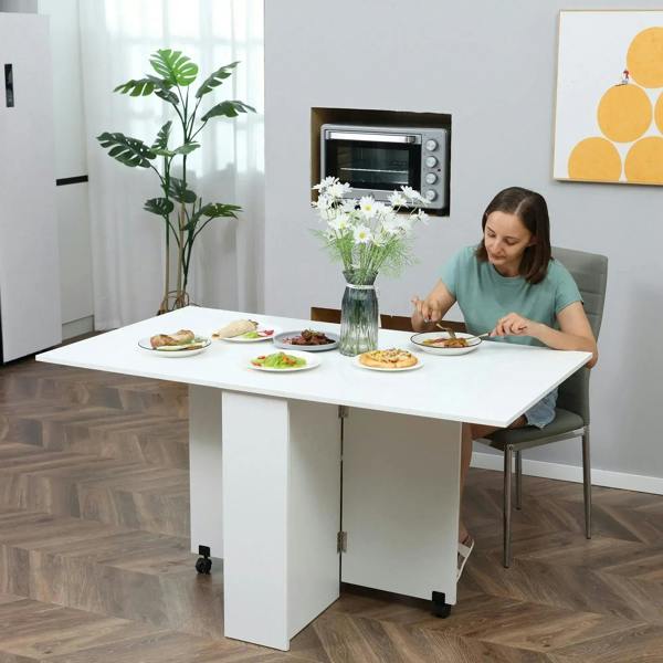 White folding drop-leaf table with two-tier shelves and rolling casters in a dining setup