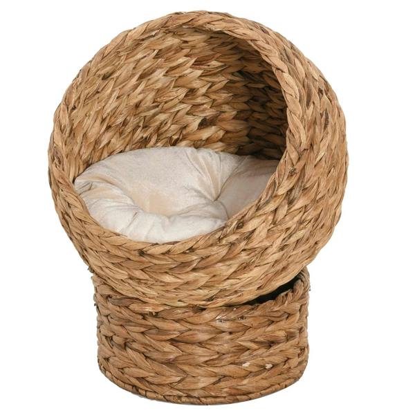 Rattan wicker cat bed with raised cylindrical base and light cushion, round dome opening