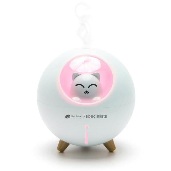 The Rio MIA Cat Childrens Essential Oil Diffuser, Humidifier, and Night Light features a cute cat inside a pink-lit window with steam rising from the top and small wooden legs—a charming addition for any child’s room.