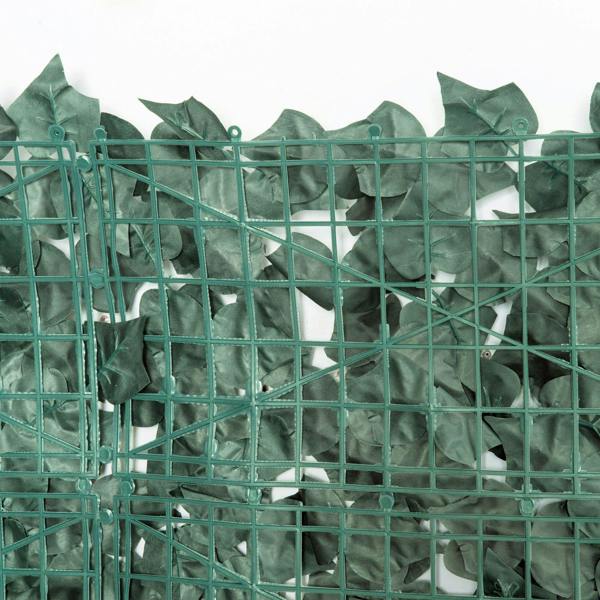 Dark green artificial leaf hedge privacy fence close-up with mesh grid frame