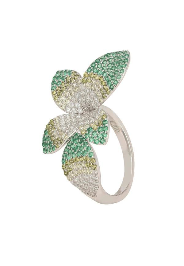 Flower-shaped ring with green and gold gemstones on a white background