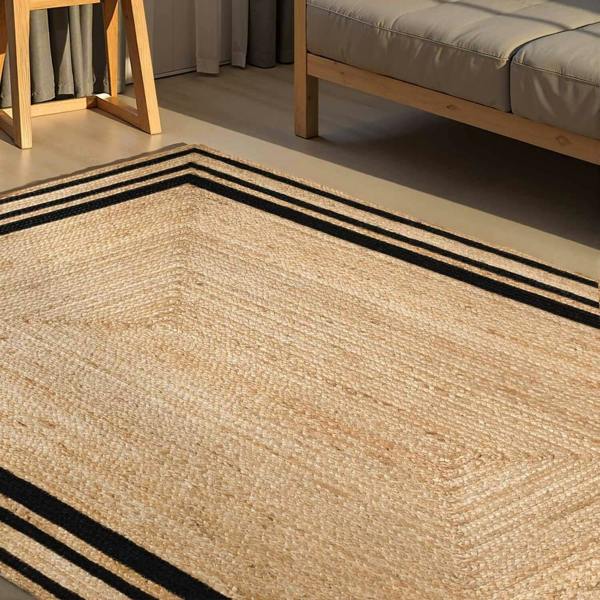 Beige woven rug with black stripes in a room setting