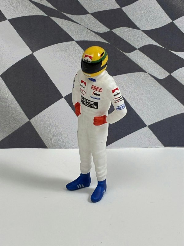 a toy figure of a race car driver