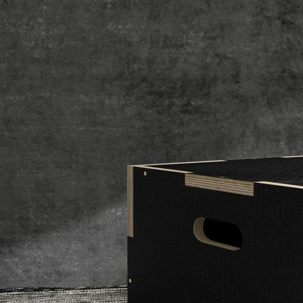 Black wooden jump box with oval handle cutout on textured side panel