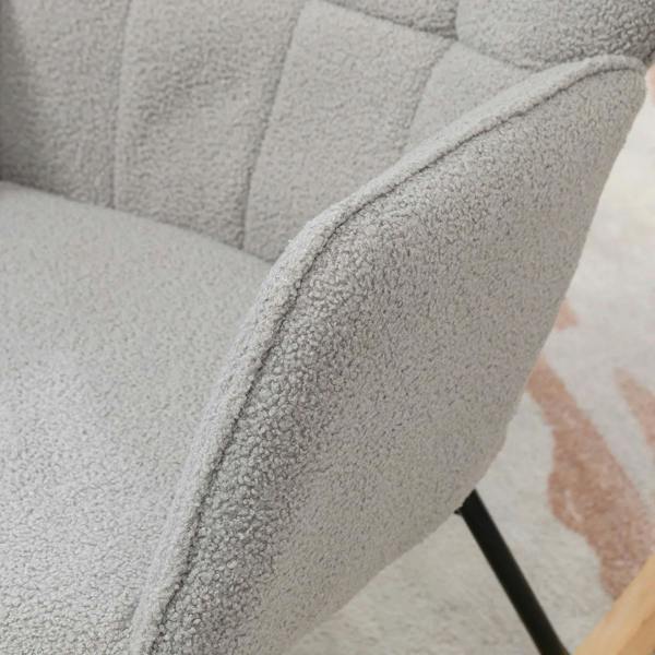 Light grey upholstered armrest and wingback backrest on a rocking chair