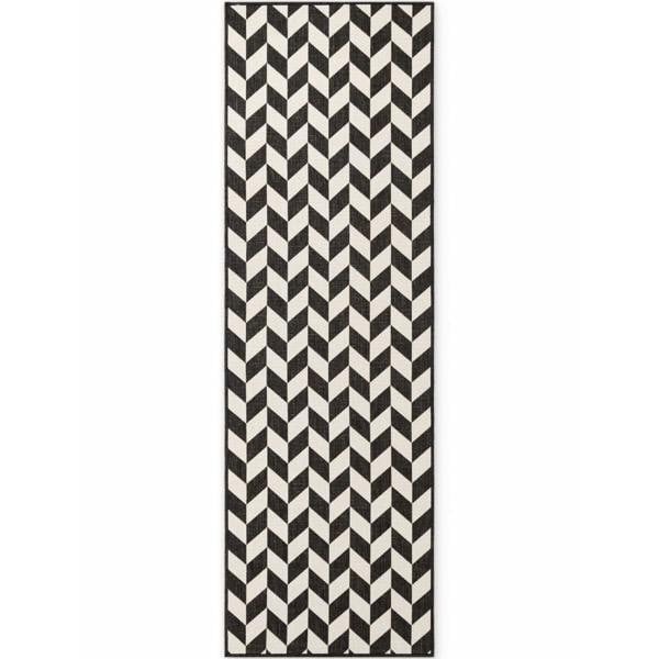 Black and white chevron patterned rug on a white background