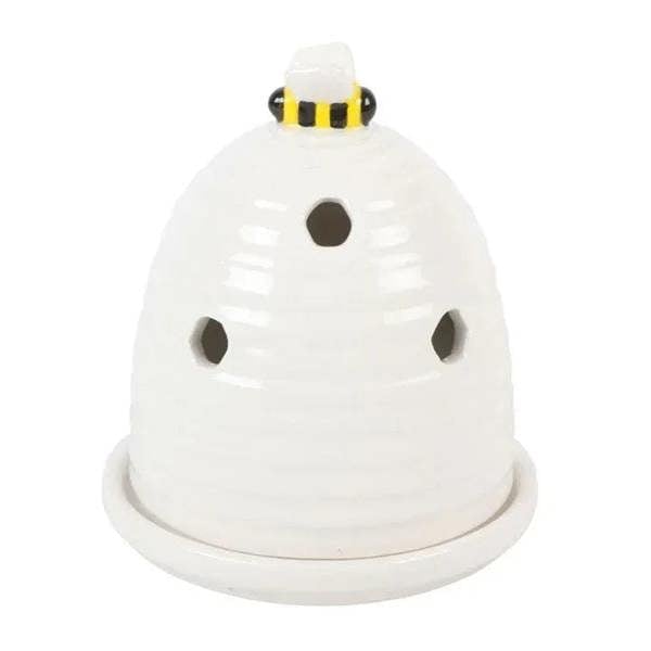 White bee-hive incense cone holder with rounded base and three dark openings