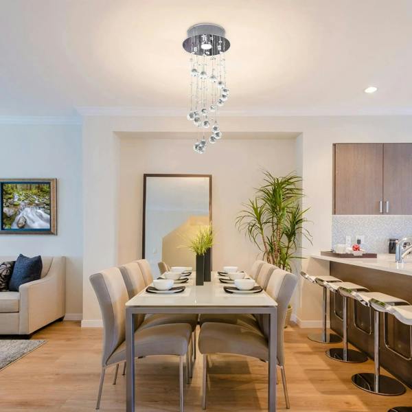 Silver crystal ceiling chandelier with cascading clear glass drops above a dining table