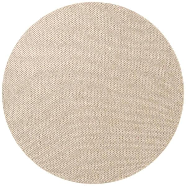 Round beige rug on a white background