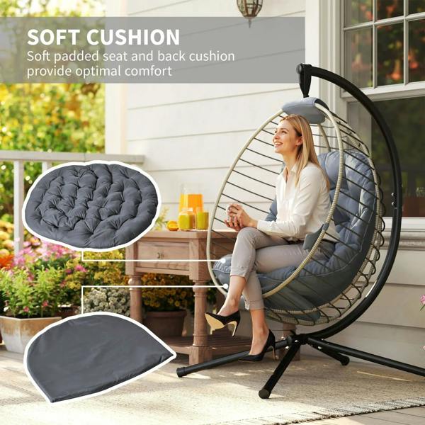 Grey hanging rattan swing chair with thick seat and back cushions on metal stand