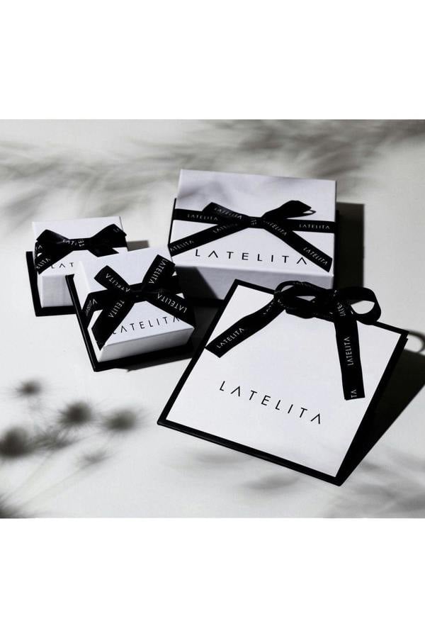LATELITA product packaging with black ribbons on a neutral background
