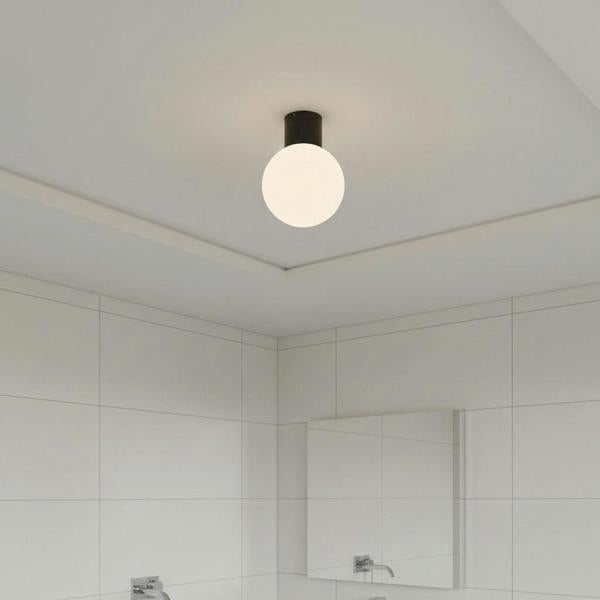 black globe bathroom ceiling light fitted in a small modern bathroom 