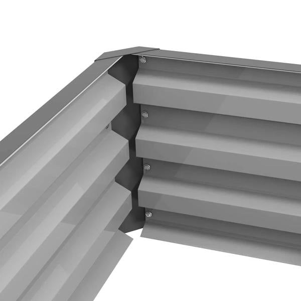Light grey raised garden bed corner joint with stacked slats and visible screws
