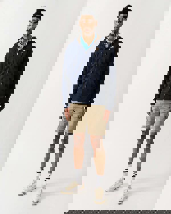 full length shot of a model wearing an Aquascutum Mens Full Zip Badge Hoodie in Navy