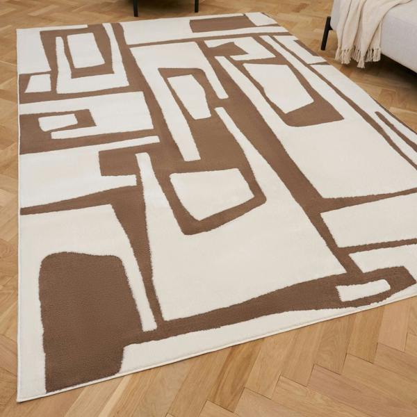 Brown and white geometric patterned rug on a wooden floor