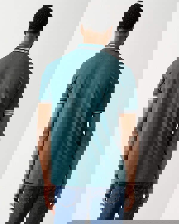 back shot of a model wearing a BOSS Green Paddy Mens Cotton-Piqué Polo Shirt with Contrast Logo in Open Green