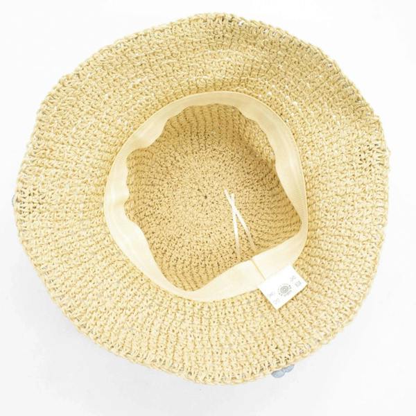 Beige straw sun hat underside view with light blue flowers and inner band