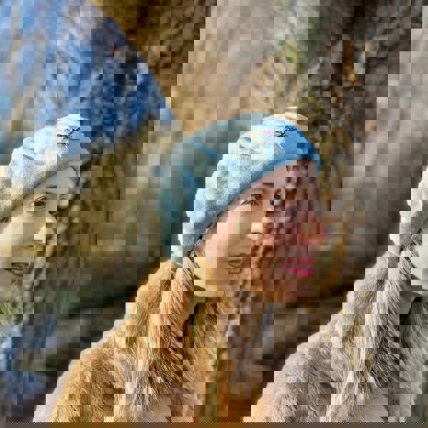 blue beret with dragonfly brooch for wedding guest