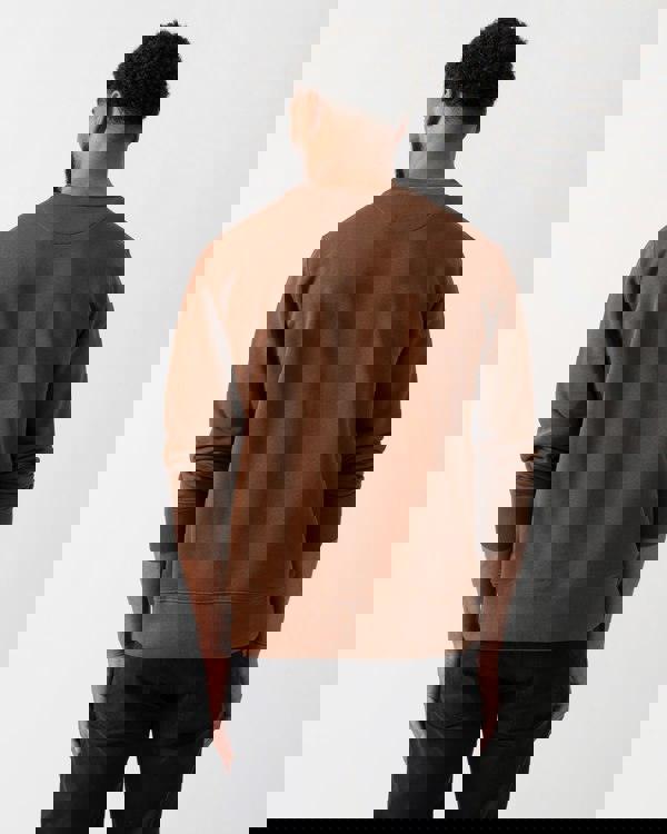 Back shot of a model wearing a GANT Mens Regular Fit Shield Logo Crew Neck Sweatshirt in Mahogany Brown