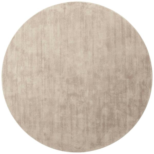 Round beige rug on a white background