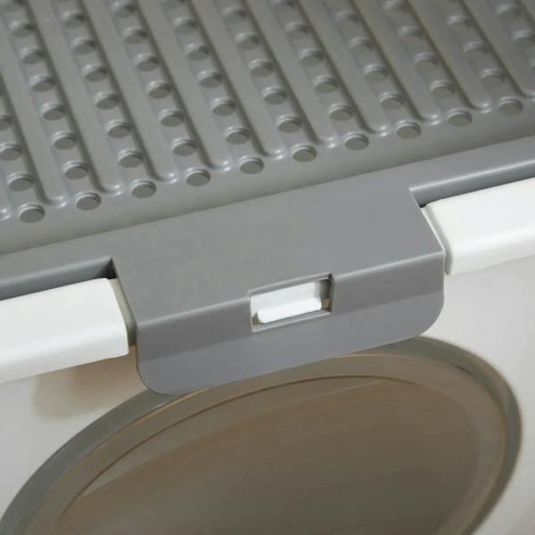 Close-up of gray front flap on white enclosed cat litter box