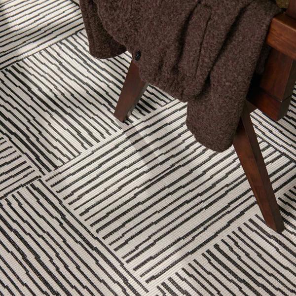 Patterned carpet with a wooden chair and brown fabric draped over it