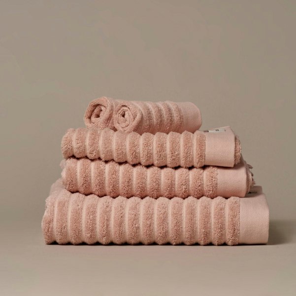 Organic cotton blush pink bathroom towels. Super soft ribbed towels in four sizes: hand towel, bath towel, bath sheet and face cloths. 