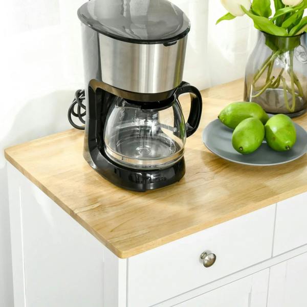 Light wood top of a white cabinet with coffee maker and drawer knob