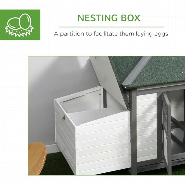 Grey nesting box section inside the coop with partition and hinged access door.