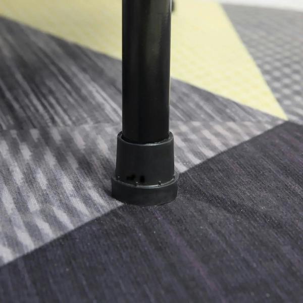 Black rubber foot cap on a mini trampoline leg attached to the blue padded frame