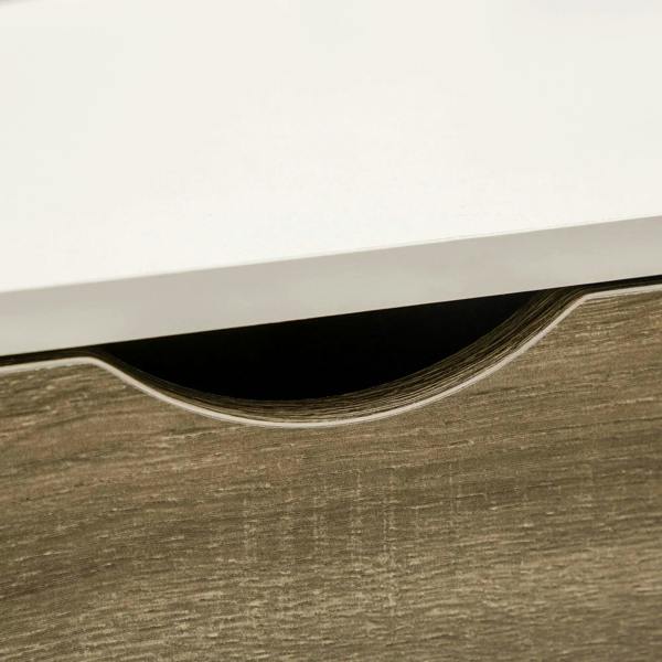 Close-up of dark wood drawer panel with curved cutout under white tabletop