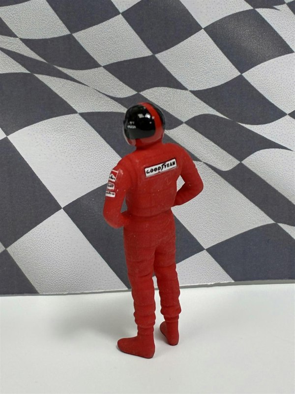 a toy figure in red suit