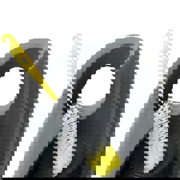 Sleek gray electric water feature with a curved design, featuring a yellow cleaning brush resting against its side