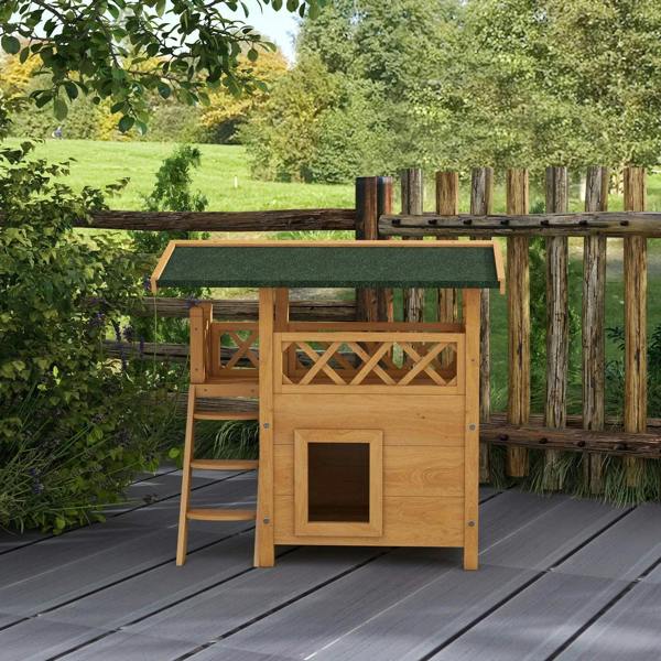 Outdoor wooden cat house with green felt roof, balcony, ladder stairs, and front square door