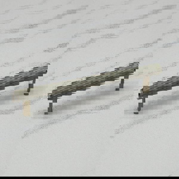 An antique brass reeded T-bar handle