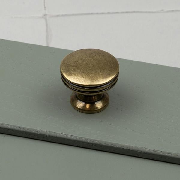An antique brass round circular knob 