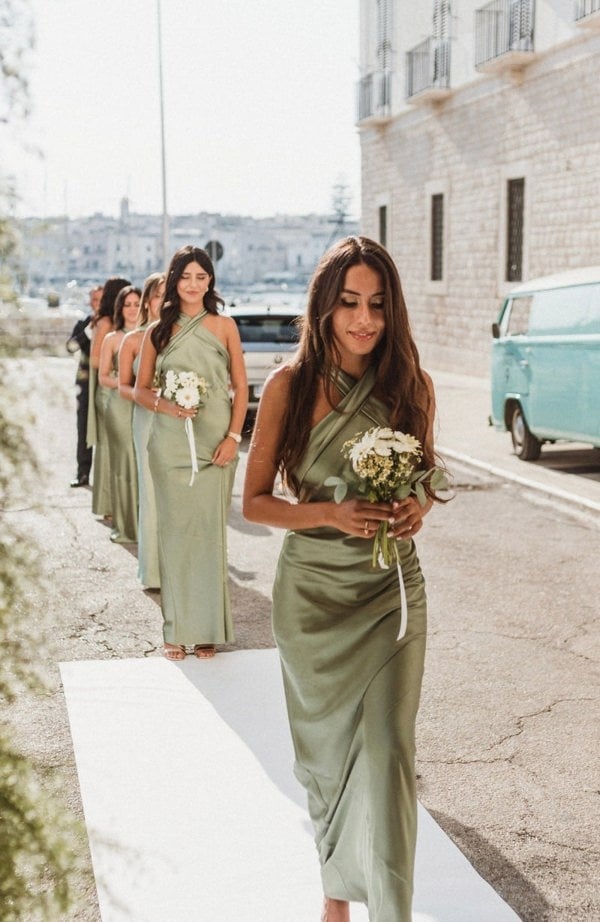 Bridesmaids wearing halterneck sage green satin dresses
