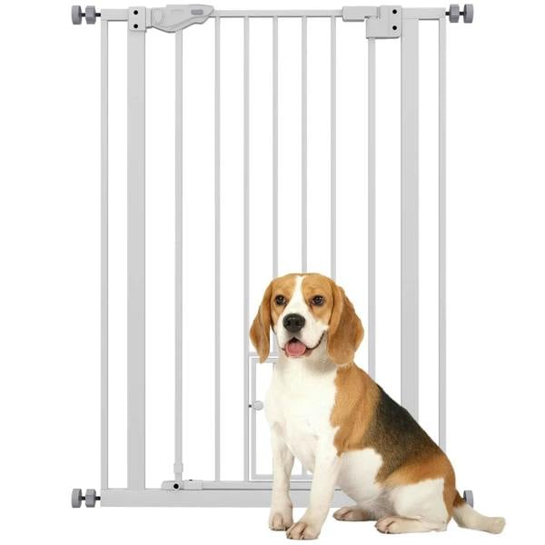 White indoor pet gate with vertical bars and top latch; beagle sits behind it