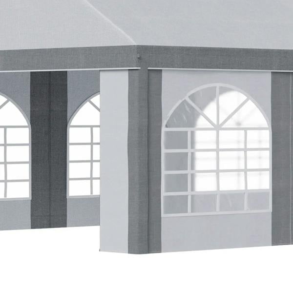 Close-up of light grey marquee gazebo side panel with white arched window opening