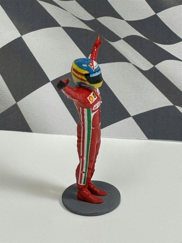 a toy figurine of a race car driver