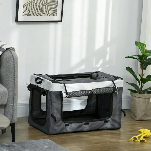 Foldable grey pet carrier bag with mesh panels and top handle indoors