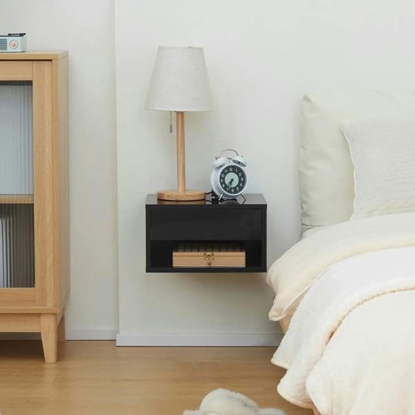 High-gloss black floating bedside table with open shelf and alarm clock
