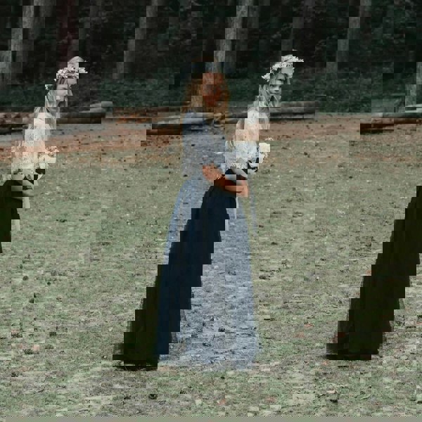 young girl stood in the woods
