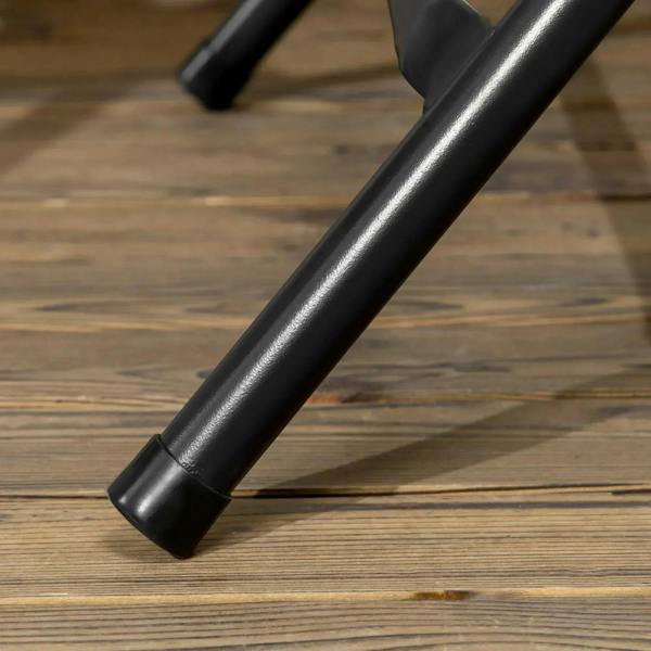 Black steel table leg end on the floor, part of a round foldable garden table